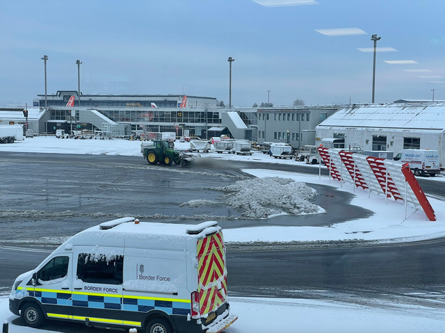 <p>A plough clears the runway at Glasgow airport after heavy snow</p>